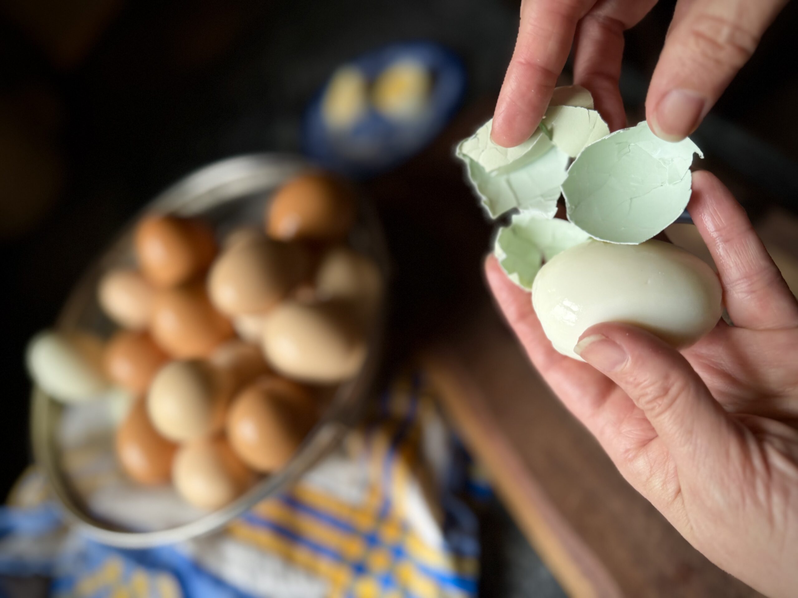 Easy-peel steamed farm fresh egg with shell slipping away cleanly after cooking