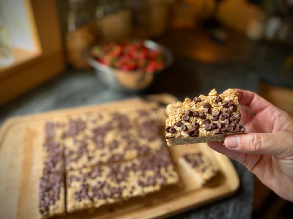 Chewy chocolate chip granola bars topped with mini chocolate chips, cut and ready to serve.