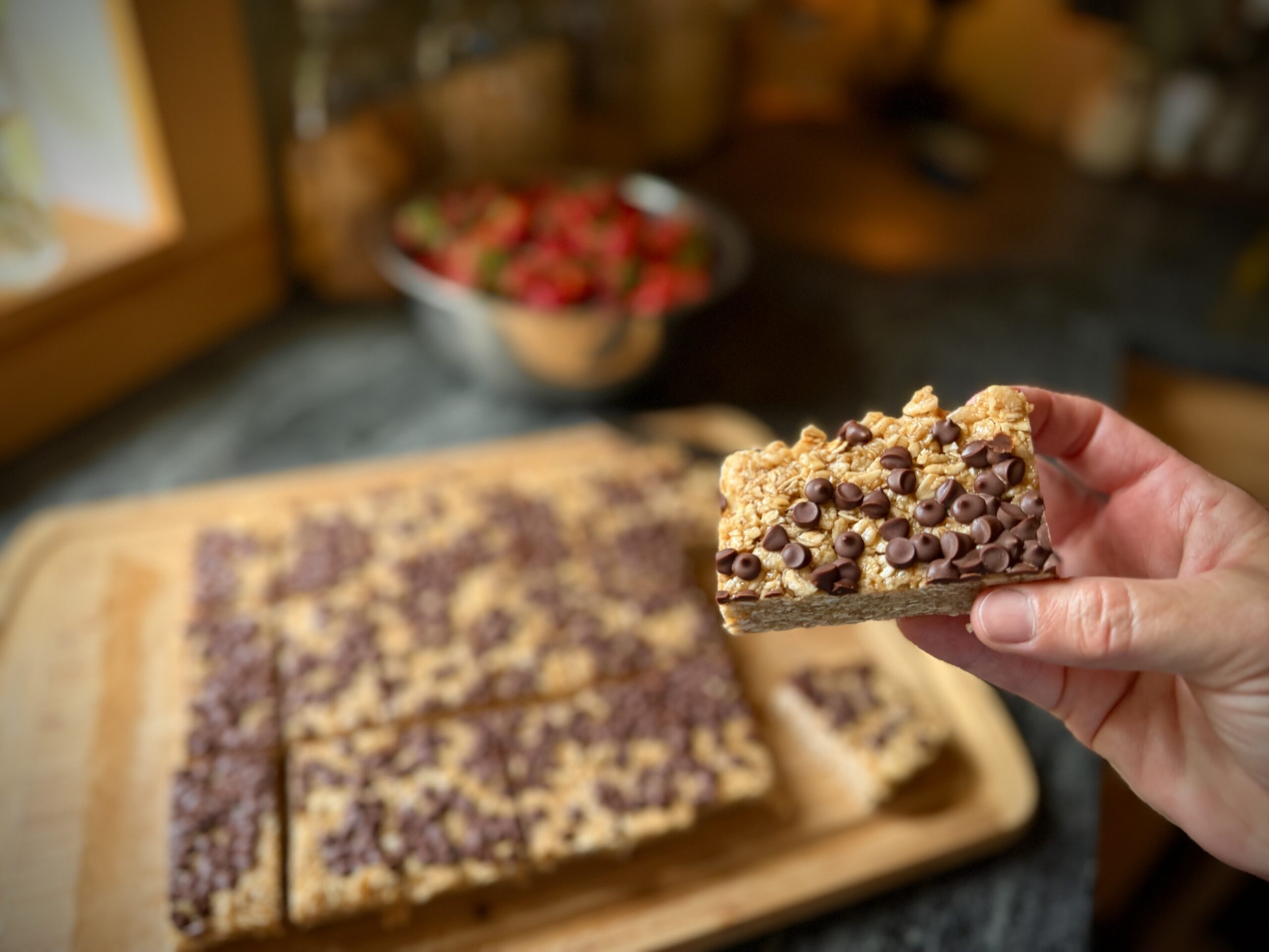 Chewy chocolate chip granola bars topped with mini chocolate chips, cut and ready to serve.