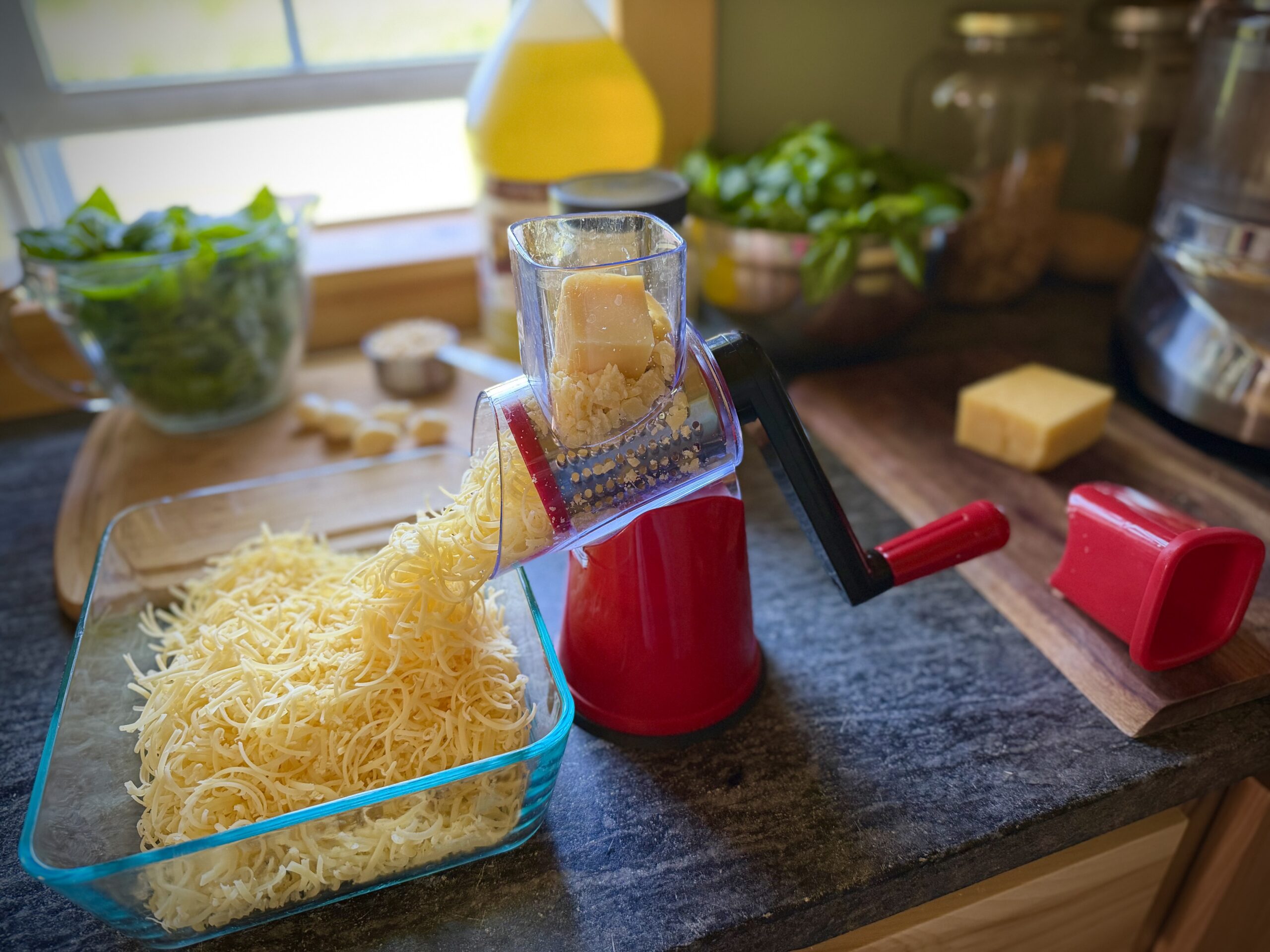 Fresh Parmesan cheese being grated for homemade basil pesto.