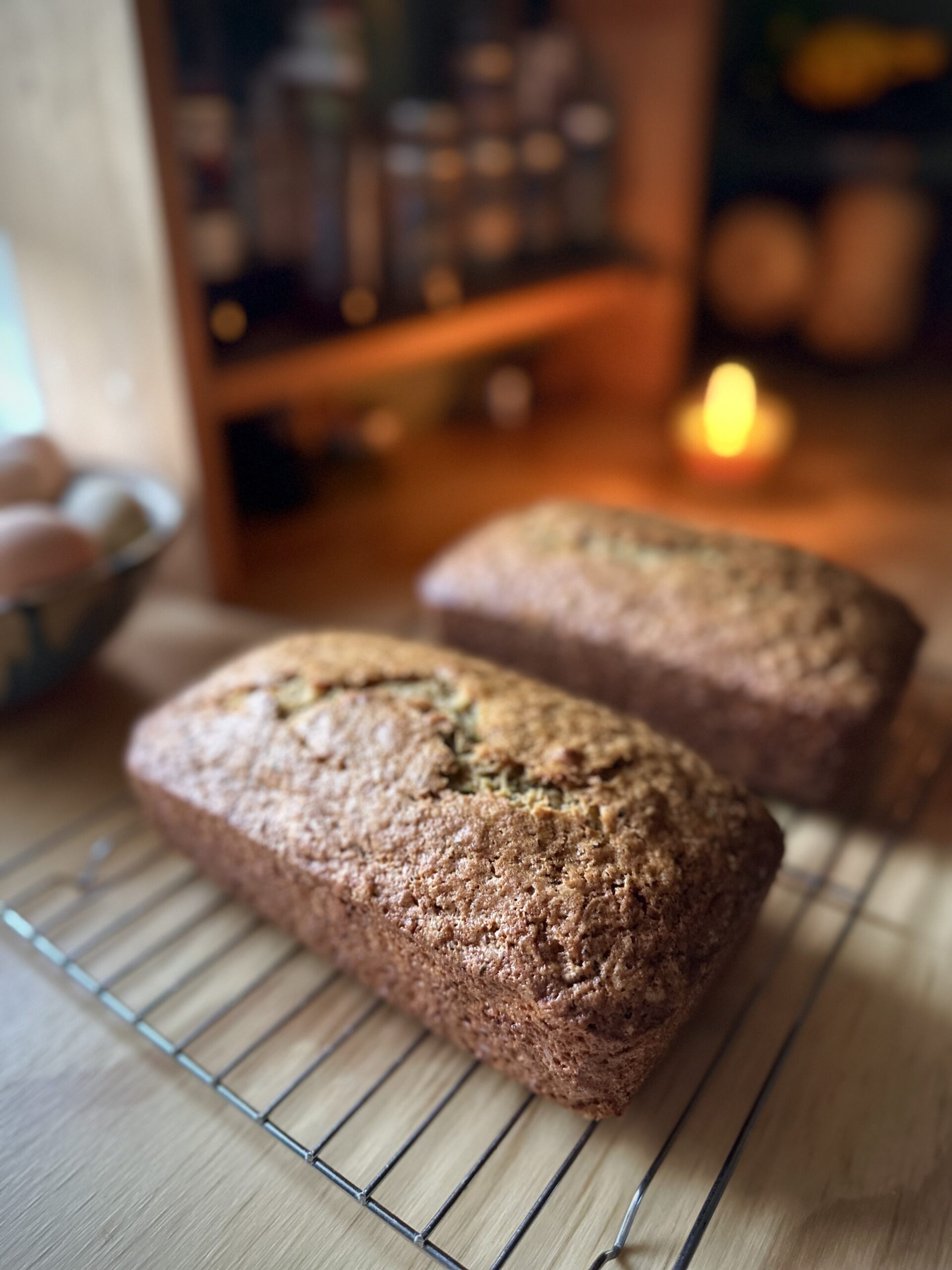 Two loaves of old-fashioned zucchini bread cooling on a wire rack