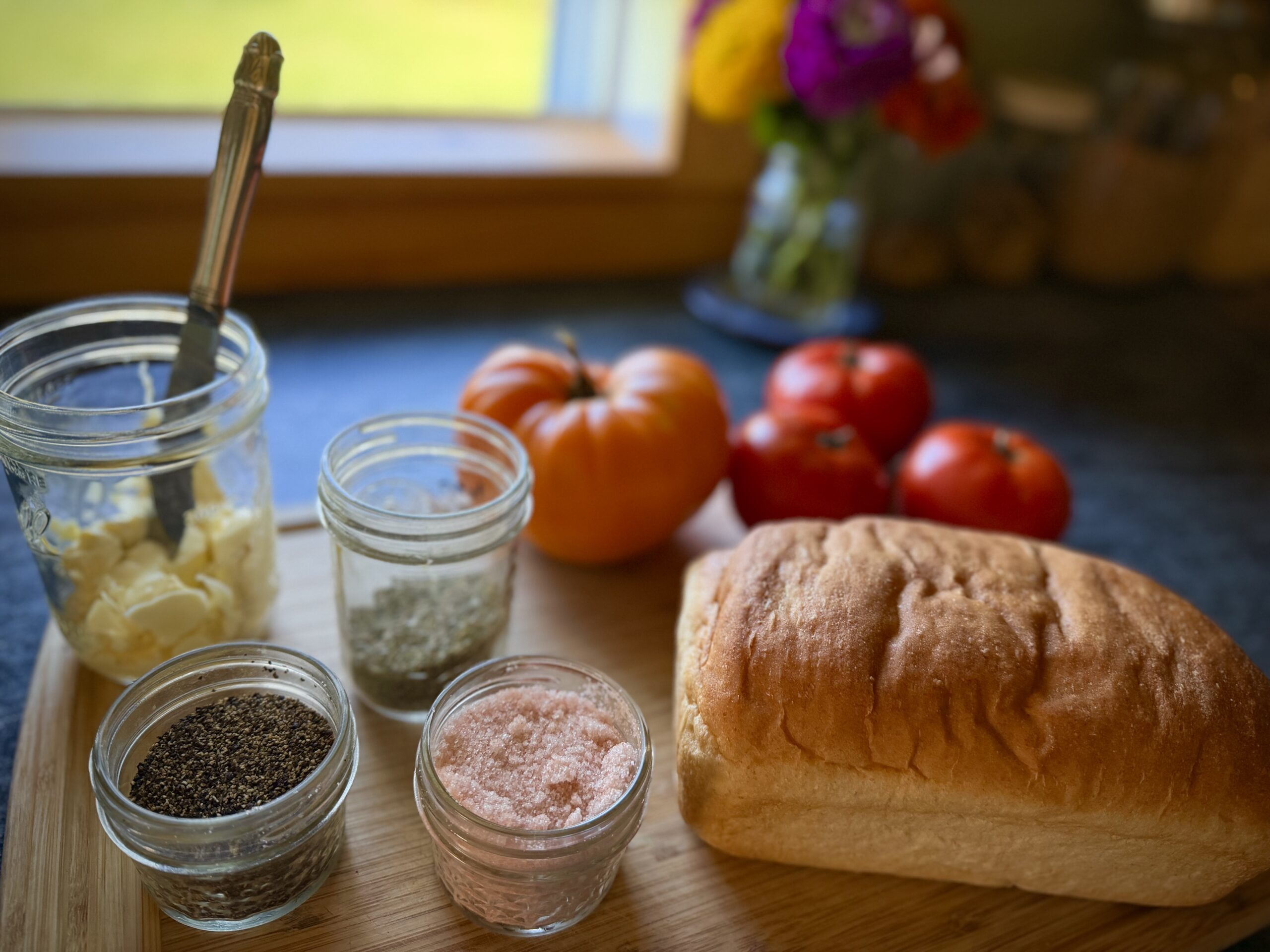 Bread, fresh garden tomatoes, mayonnaise, salt, pepper, and herbs for tomato toast