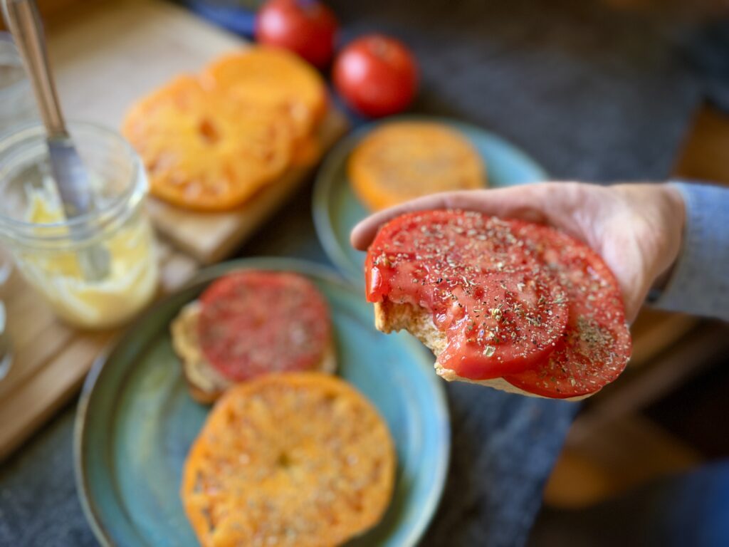 Fresh tomato toast with mayonnaise, salt, pepper, and herbs