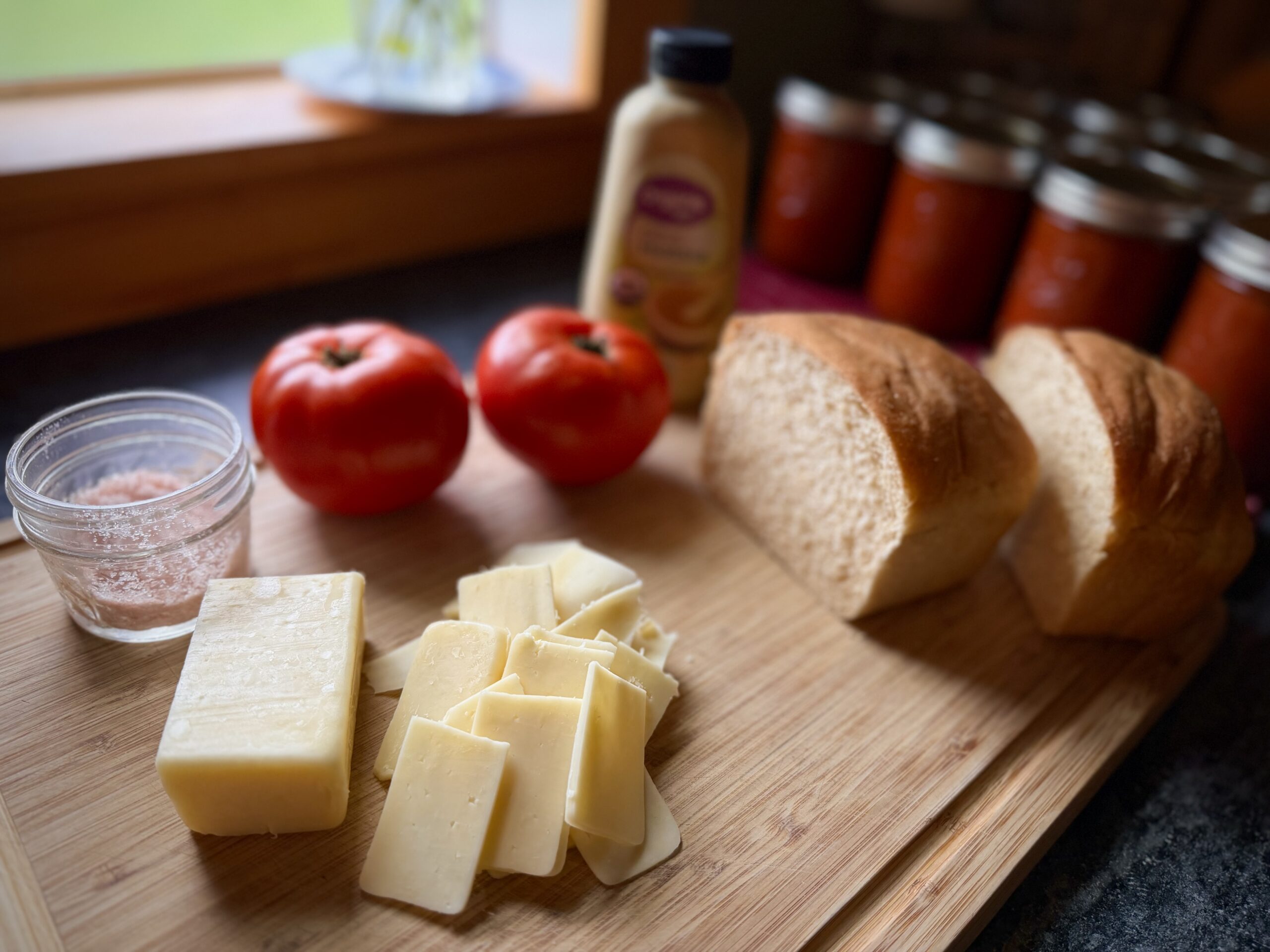 Homemade bread, cheddar cheese, garden tomatoes, mustard, and salt for tomato grilled cheese