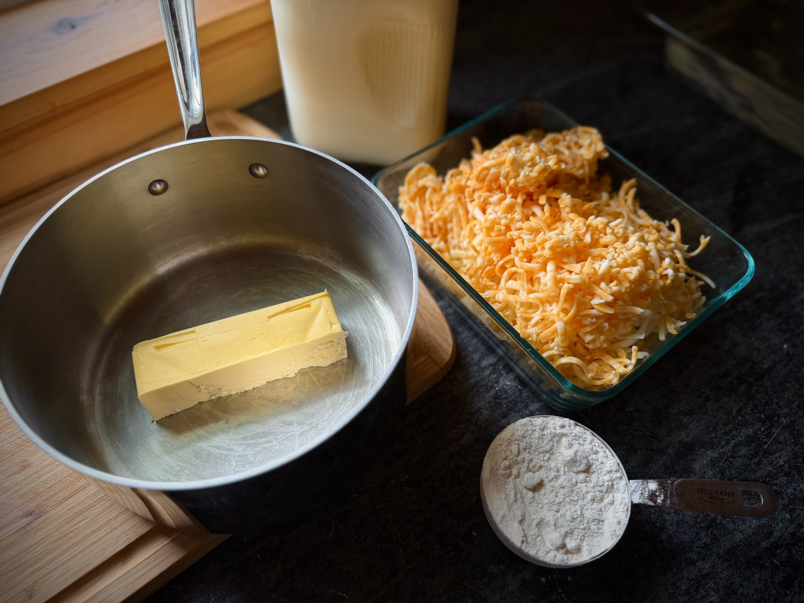 Butter, flour, whole milk and grated cheese for homemade farmhouse macaroni and cheese